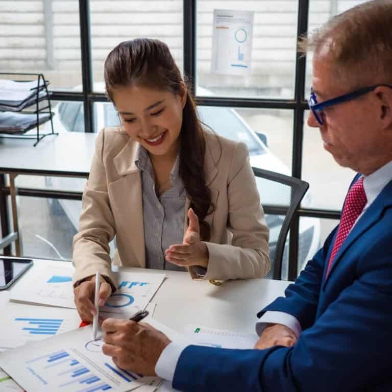 Business professionals discussing tax strategies in an office setting.