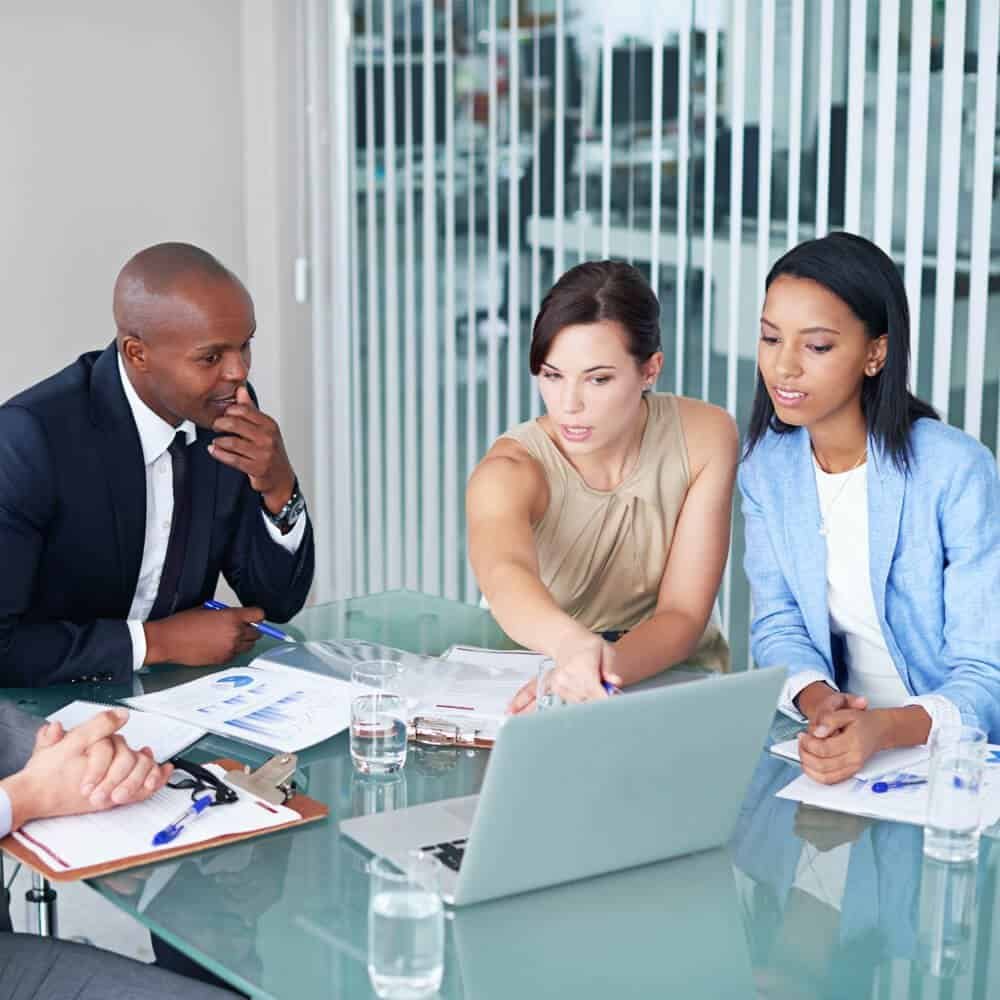 Tax consultation meeting with diverse professionals at a modern office.